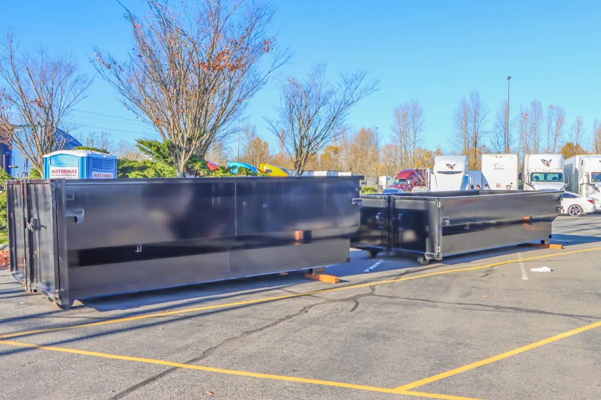 Professional dumpster rental service with roll-off container on residential driveway in Pittstown